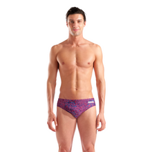 Load image into Gallery viewer, Man wearing a red and blue swim brief with a brand logo on a white background