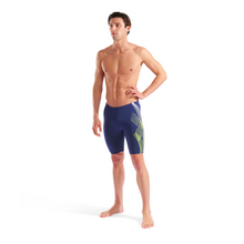 Load image into Gallery viewer, Man wearing blue swim jammers with a logo on a white background