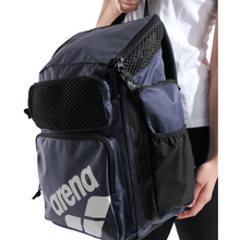 Load image into Gallery viewer, Navy backpack with black accents and 'arena' branding held by a person.