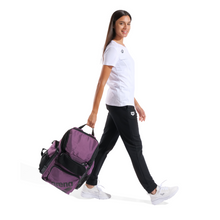 Load image into Gallery viewer, Woman walking with a purple bag on a white background