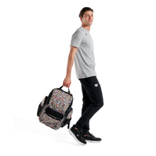 Load image into Gallery viewer, Person holding a skull-patterned backpack on a white background