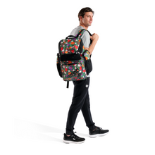 Load image into Gallery viewer, Person wearing a colorful floral backpack on a white background