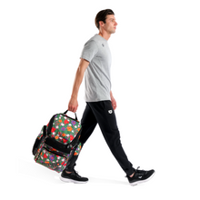 Load image into Gallery viewer, Man walking with a floral-patterned backpack on a white background