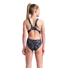 Load image into Gallery viewer, Girl wearing a black and white geometric patterned swimsuit on a white background
