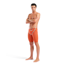 Load image into Gallery viewer, Man wearing orange racing jammers with teal taping and arena branding
