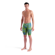 Load image into Gallery viewer, Full-length of a man in an arena green and blue snakeskin Powerskin ST NEXT racing suit
