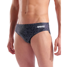 Load image into Gallery viewer, Man wearing black patterned swim briefs with Arena logo on a white background
