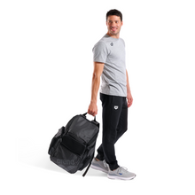 Load image into Gallery viewer, Man holding a black bag with a white background
