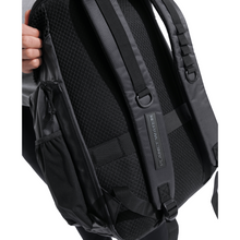 Load image into Gallery viewer, Black backpack with &quot;Planet Water&quot; on strap on a white background
