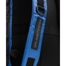Load image into Gallery viewer, Close-up of a blue backpack strap with &quot;Planet Water&quot; branding and D-buckle on a black background
