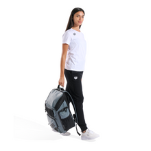 Load image into Gallery viewer, Woman holding a sage green backpack with a white background
