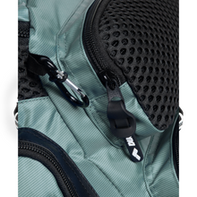 Load image into Gallery viewer, Close-up of a sage green backpack with a black zipper, a carabiner, and mesh accents on a white background
