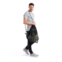 Load image into Gallery viewer, Man holding a black mesh bag with swim equipment inside on a white background
