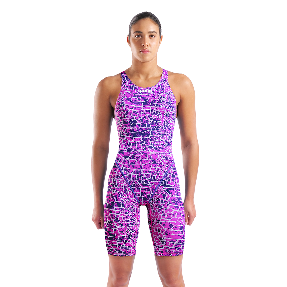 Woman in an arena pink and purple snakeskin Powerskin ST NEXT racing suit